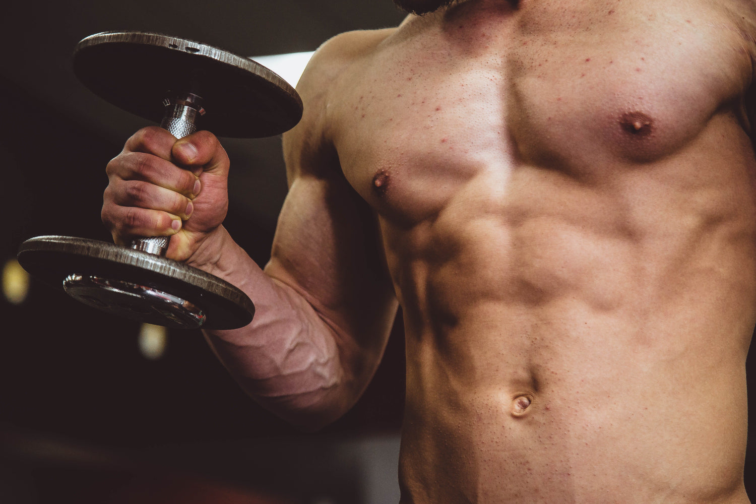 Lean muscle man with dumbbell