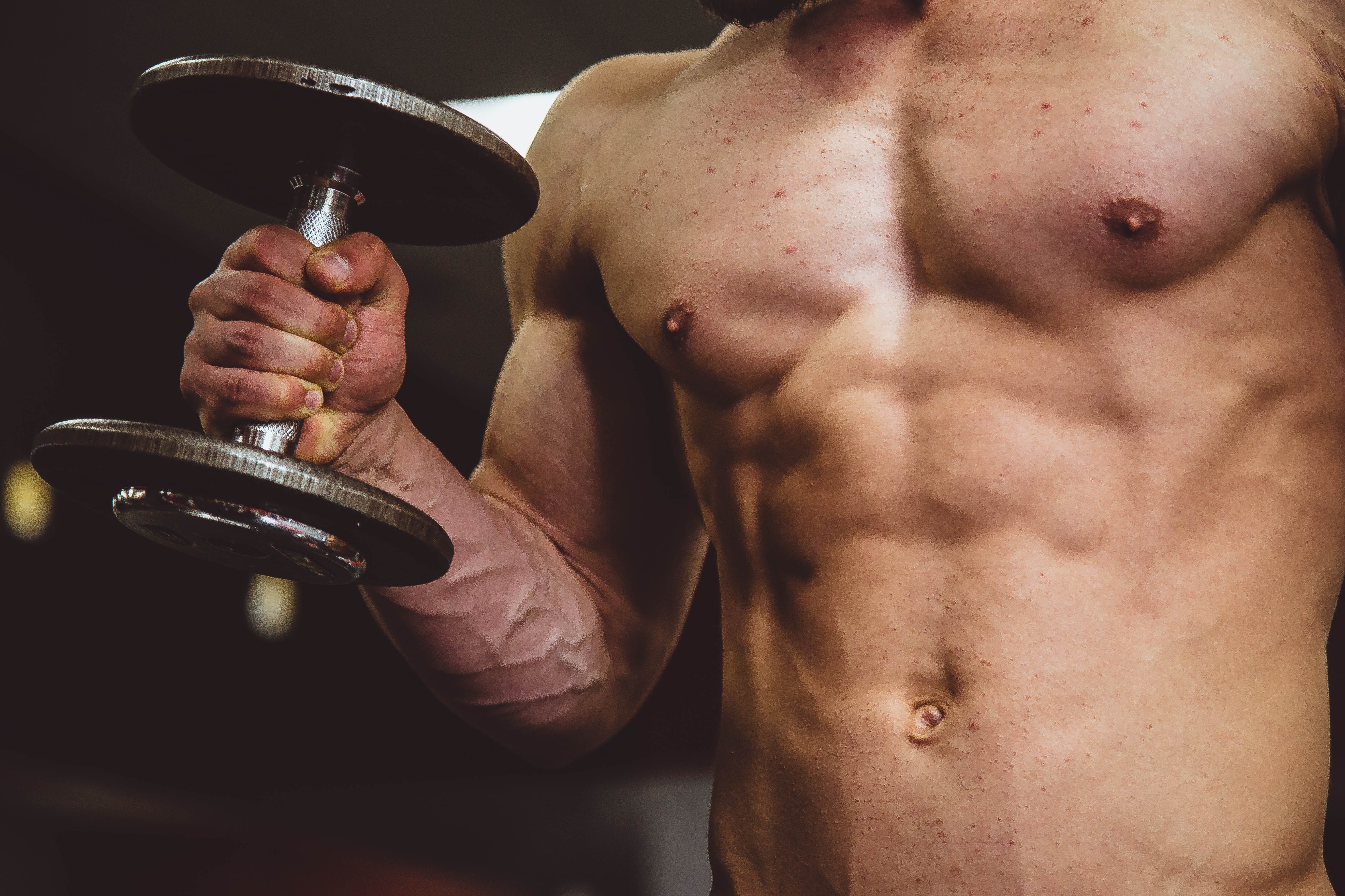 Lean muscle man with dumbbell