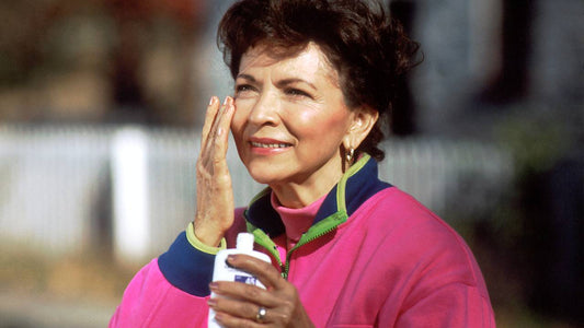 woman applying suncream to protect her skin