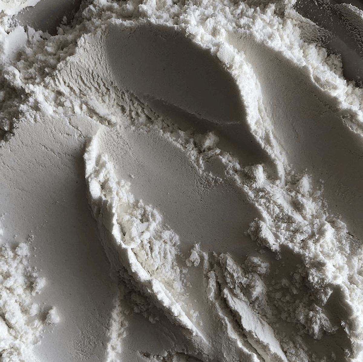 A close-up of Taurine, with visible texture and shadows.